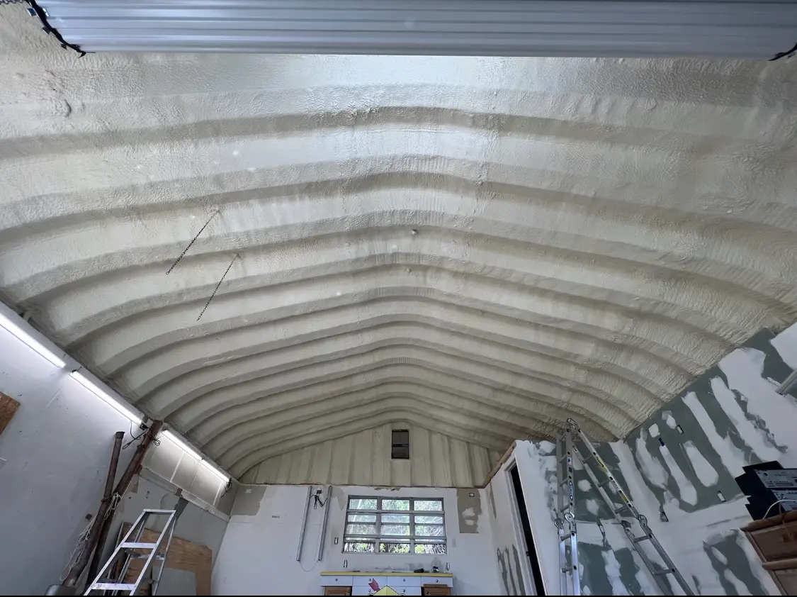 Spray polyurethane foam applied to the underside of a metal roof deck in Amory